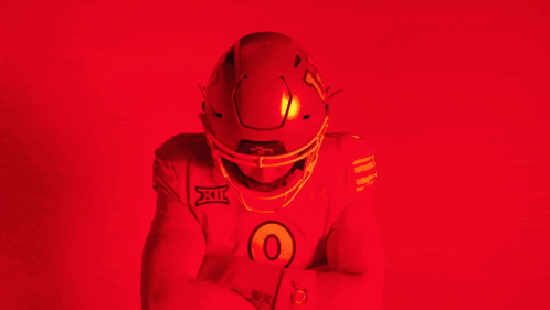 Man in Red Under Armour Jersey and Football Helmet