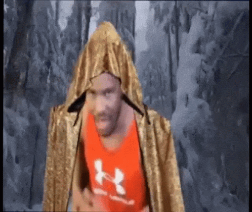 Man in Red Under Armour Tank Top and Gold Cape