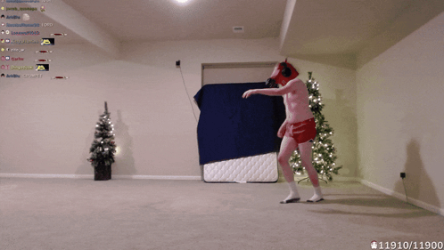 Man In Red Underwear Dancing In Front Of Christmas Tree And Blue Blanket GIF