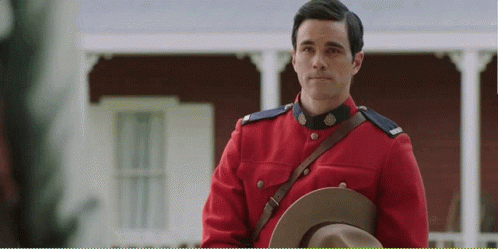 Man in Red Uniform Holding Hat