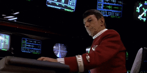 Man in Red Uniform Sitting at Desk With Monitor Saying 04077