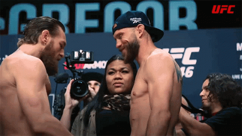 Man in Reebok Hat Standing Next to Another Man