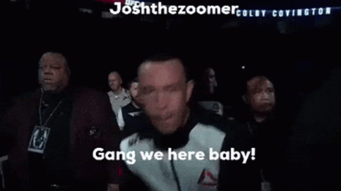 Man In Reebok Jacket Standing In Crowd GIF
