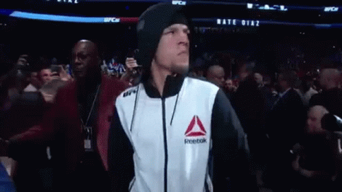 Man in Reebok Jacket Walking Through Crowd