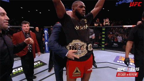 Man in Reebok Shorts Holding UFC Belt