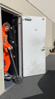 Man In Reeses Suit Driving Scooter GIF