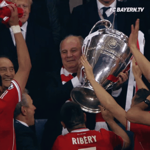 Man in Ribery Jersey Holding Trophy