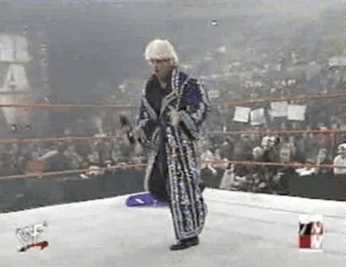 Man In Robe Holding Microphone In Wrestling Ring GIF