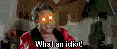 Man in Robe Sitting in Front of Lamp Says What an Idiot
