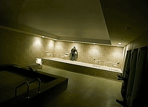 Man in Robe Standing in Bathtub