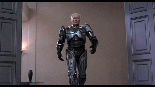 Man in Robot Suit Standing in Room