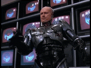 Man in Robotic Suit in Front of TV Wall