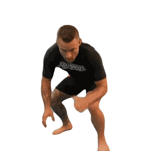 Man in Rogues Shirt Squatting