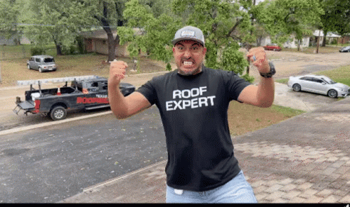 Man in Roof Expert Shirt with Truck