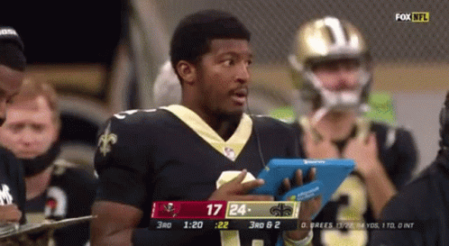 Man in Saints Jersey Holding Tablet