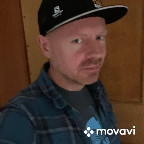 Man In Salomon Hat Plaid Shirt Smiles GIF