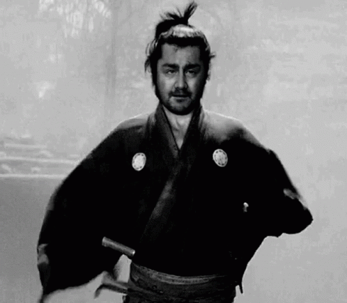 Man In Samurai Costume Holding Sword Black And White GIF
