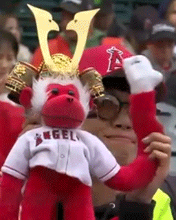 Man in Samurai Hat with Stuffed Monkey Saying Angels