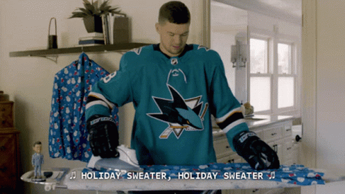 Man in San Jose Sharks Jersey Ironing Sweater