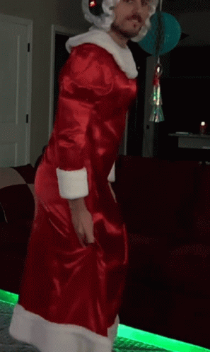 Man In Santa Costume Dancing In Front Of Couch GIF