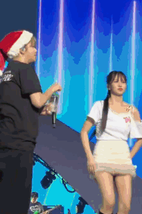 Man in Santa Hat Next to Woman