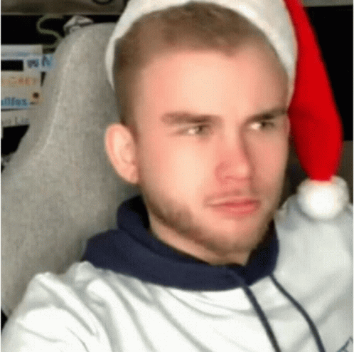 Man In Santa Hat Sitting In Chair GIF