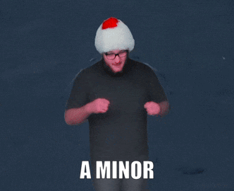 Man in Santa Hat Standing Before Hopscotch