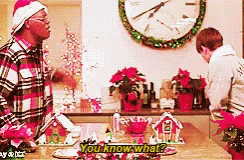 Man In Santa Hat Talking To Man GIF