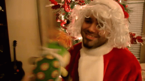 Man in Santa Suit Holding Stuffed Animal