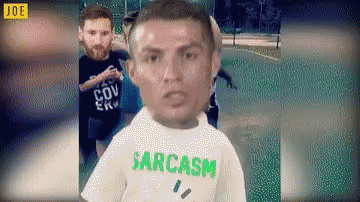 Man in Sarcasm T-Shirt Standing in Front of Group