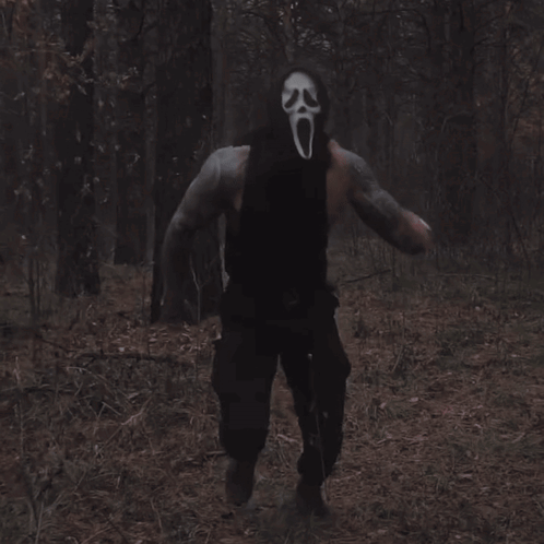 Man in Scream Mask Walking Through Woods