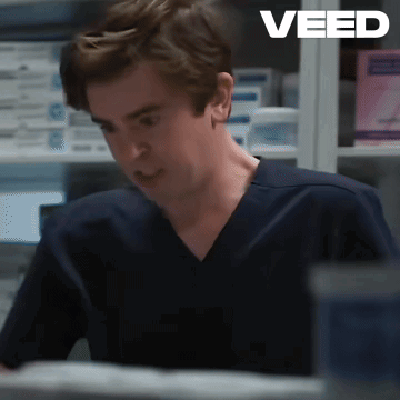 Man in Scrub Top Sitting at Desk Saying Veed
