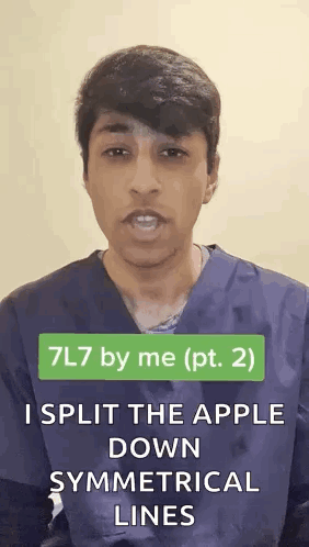 Man in Scrub Top Splitting Apple Along Symmetrical Lines