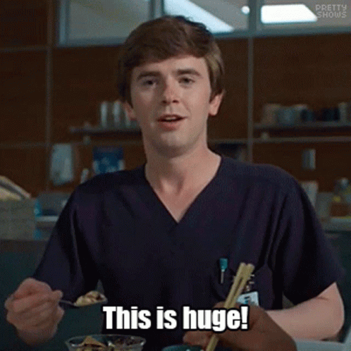 Man in Scrubs Holding Spoon And Chopsticks Saying This Is Huge