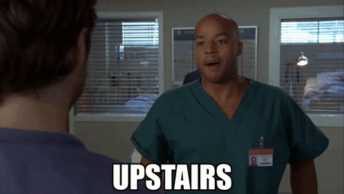 Man In Scrubs Talking With Upstairs Text GIF