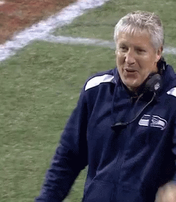 Man in Seattle Seahawks Jacket on Football Field