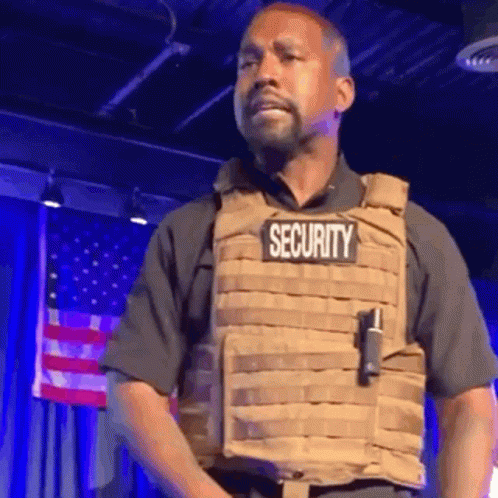 Man in Security Vest Standing on Stage