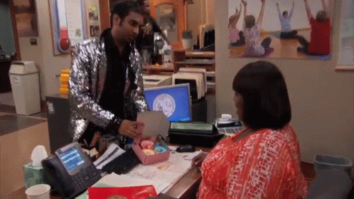 Man In Sequined Jacket Giving Woman Gift GIF