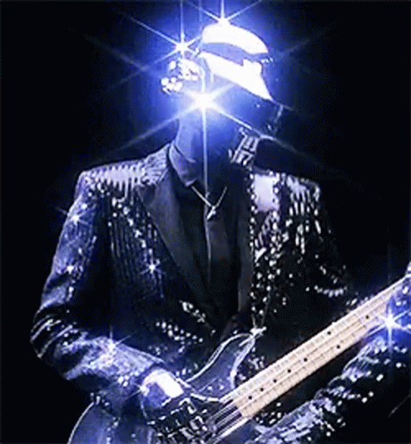 Man in Sequined Suit Playing Guitar