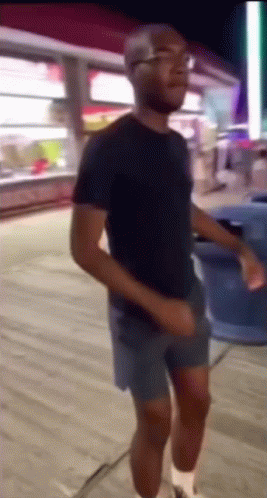 Man In Shorts And Black Shirt Dancing GIF