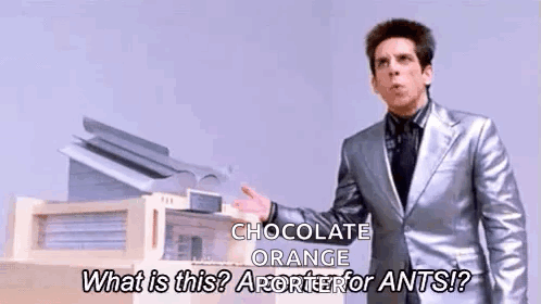 Man in Silver Suit Talking About Chocolate Orange