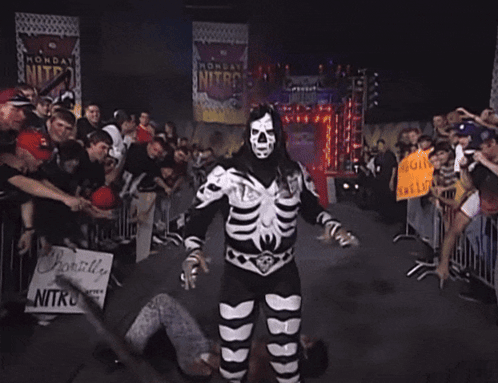 Man in Skeleton Costume Holding Sign Probably Live Nitro