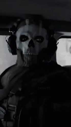 Man in Skull Mask and Headphones in Car