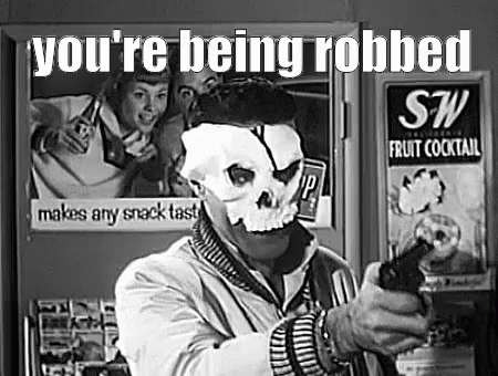 Man in Skull Mask Holding Gun by Refrigerator