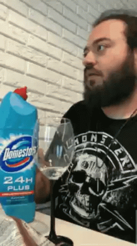 Man In Skull Shirt Holding Domestos GIF