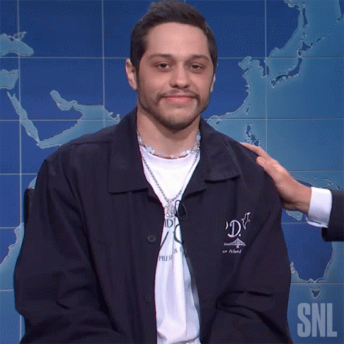 Man in SNL Jacket Patted on Shoulder