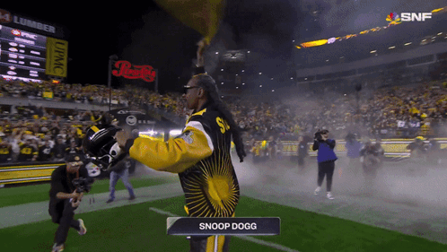 Man In Snoop Dogg Outfit Standing On Field GIF