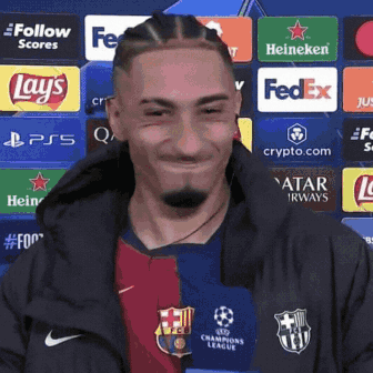 Man In Soccer Uniform Smiling In Front Of FedEx Lays Heineken Ads GIF