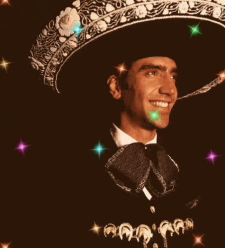 Man in Sombrero and Bow Tie Smiling With Heart