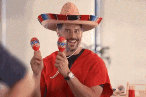 Man in Sombrero and Poncho Holding Maracas